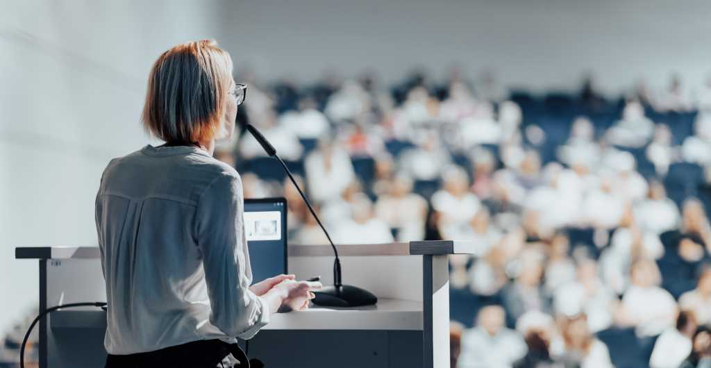 3485130-0-12380600-1723216768-woman-presenter-at-tech-conference-by-matej-kastelic-via-shutterstock.jpg